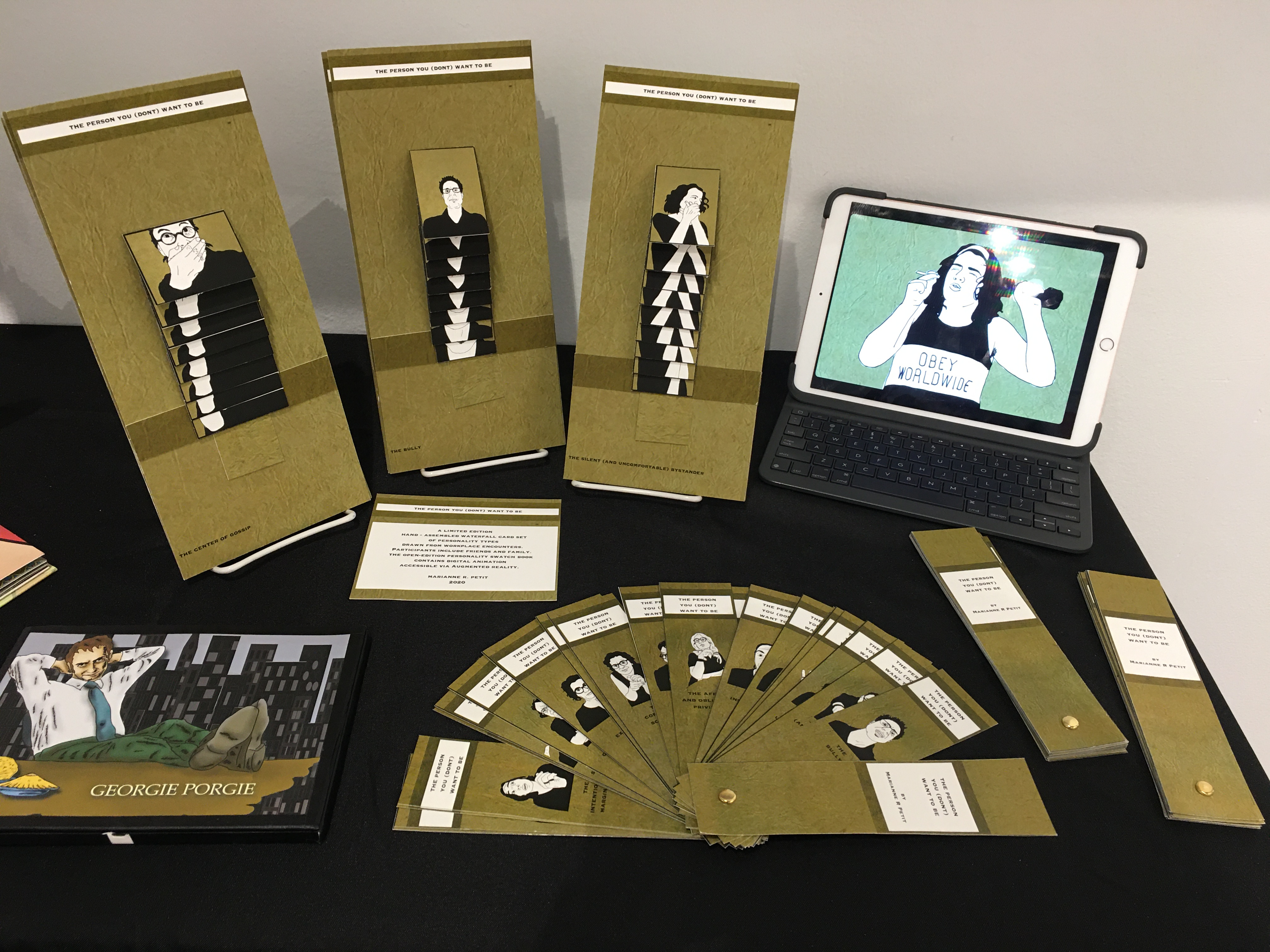 Image of table with several waterfall cards, an iPad playing animations, and several swatch books.