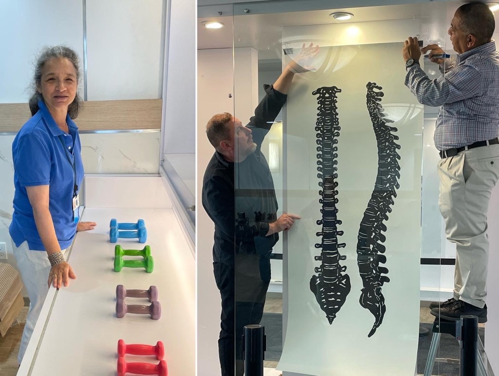 Photos of the installation. A woman in a blue shirt smiling with a series of colorful weights. To the right, two men hang a large papercut of the spine.
