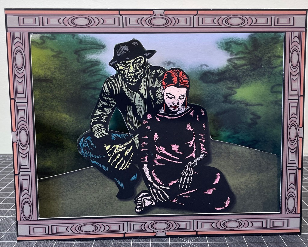 Image of a man in a hat, leaning down. A girl looking at the ground is seated before him.