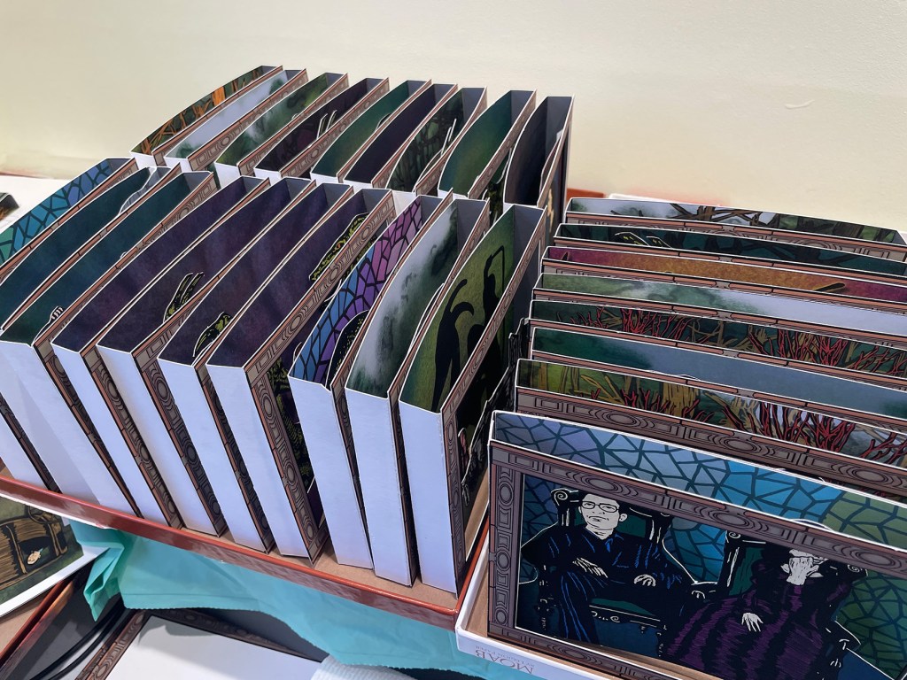 View of a box with many tunnel books stacked.